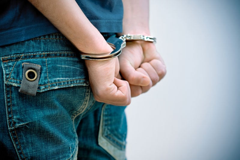 photo of young man in handcuffs in need of an attorney