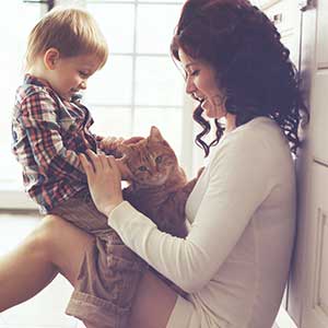 Photo of mother with her son and the cat