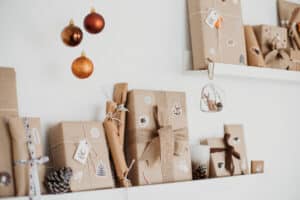 stock photo of Christmas gifts wrapped in kraft paper against a white background