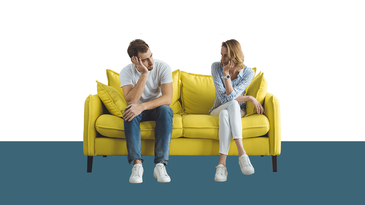 photo of a man and a woman sitting on a yellow couch