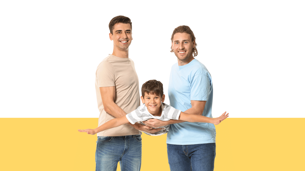 photo of two dads holding their young son from a blog post about second parent adoption