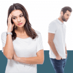 photo of woman holding her head, looking stressed, with man in background, from a blog post asking is emotional abuse domestic violence
